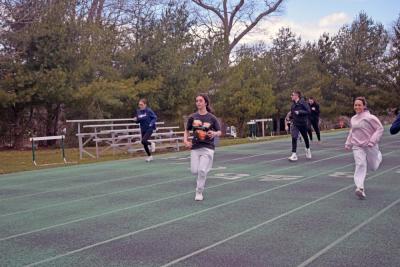 Gabriela Ligotti and Etta Hall lead a group of runners through practice. 