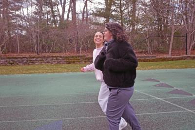 Emma Garcia and Alexis Benjamin run together. 