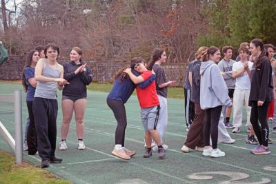 Teammates cheer each other on during 100m trials. 