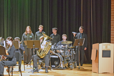 Students play the drums during the band concert. 
