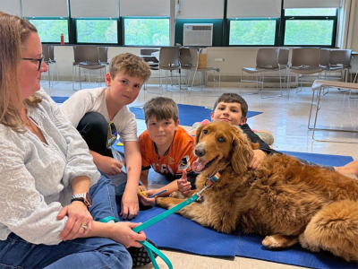 Henry Niemic, age 10, Landon Guile, age 11 and Jacob Sousa, age 9 pose with Enzo. 
