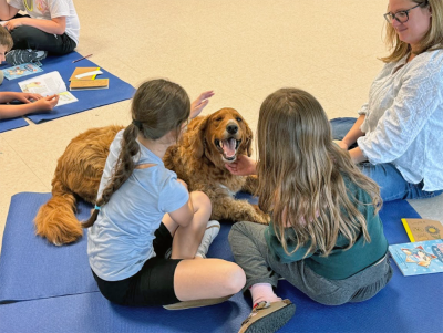 Enzo is thrilled as Vivian Amaral, age 9 and Layla Kruz, age 9 pet him. 