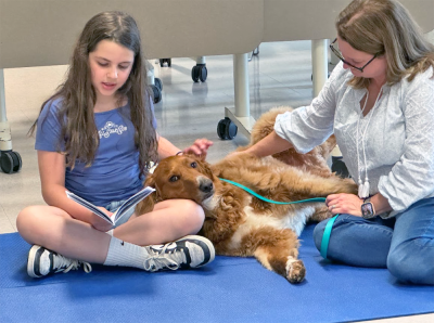Kayla Costa, age 9, reads to Enzo. 