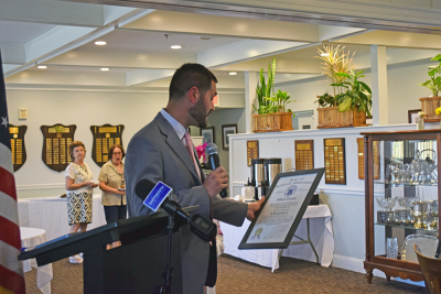 Cody Hadadd reads off some of Jackie McDonald's accomplishments. 