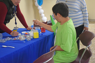 Jentzen, 11, makes some sand art. 