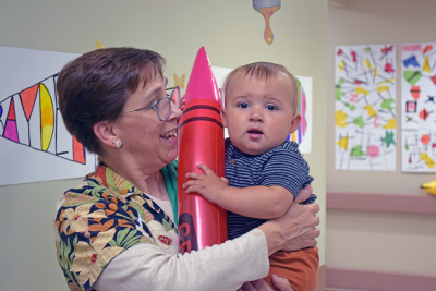 Julias, 11 months, holds a ballon crayon. 