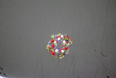 The memorial wreath floating in the water. 