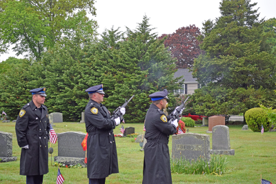 The Dartmouth Police Department performs a gun salute. 