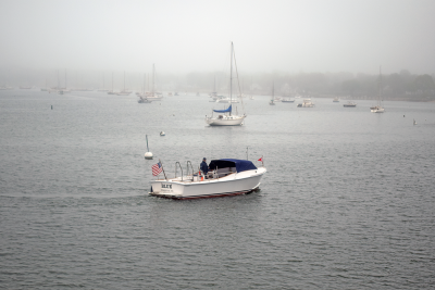 A boat floats past to view the ceremony. 
