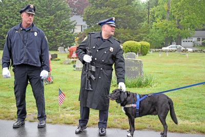 A member of the police pets a dog at the event. 