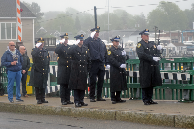 The Dartmouth Police Department performs a gun salute. 