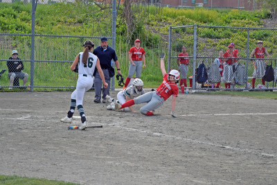 The umpire gets a New Bedford player out. 