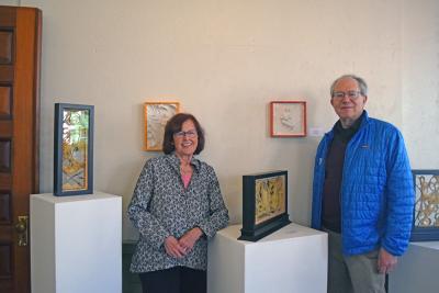 Susan Medyn and David Formanek pose in front of some of their art. Photos by Kat Sheridan