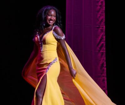 Kercheena Pamphile wears a yellow gown that represents her personality. Photos by Steve Smith Photography