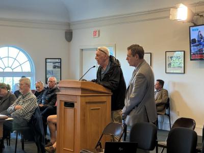 Michael Woyciechouski speaks with Town Counsel Anthony Savastano standing nearby. 