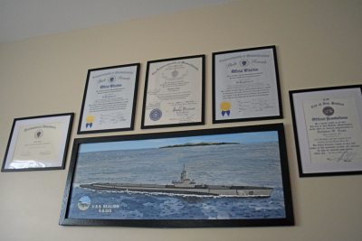 Citations and a painting of the Japanese battleship that Enos' submarine sunk. 