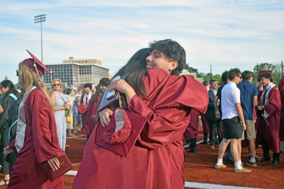 Two students hug.