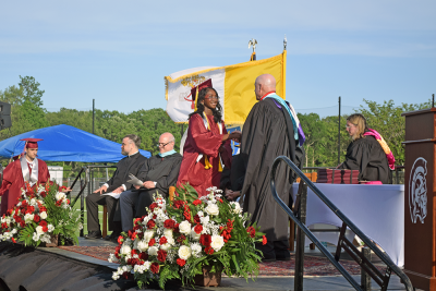 A student receives her diploma. 