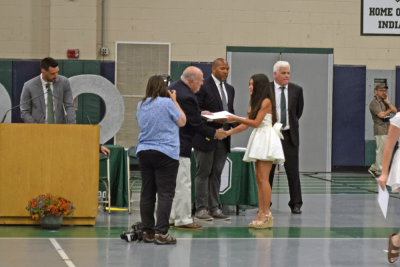 A student receives her diploma. 