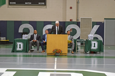 Peter Rossi welcomes the families and graduates. 