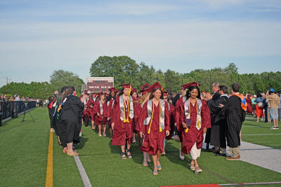 The students walk through the tunnel of faculty. 