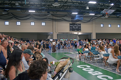 The crowd overspilled from the bleachers to the sides of the court. 