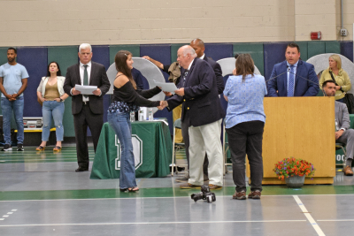 A student receives her diploma. 