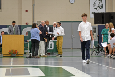 A student reveives his diploma. 