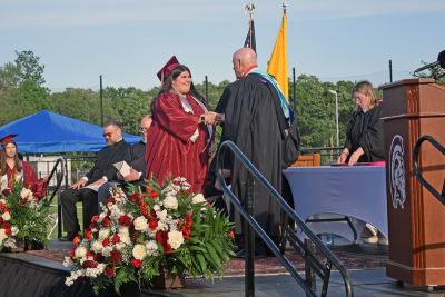 A student receives her diploma. 