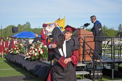 A student hugs a member of the Bishop Stang staff after he received his diploma. 