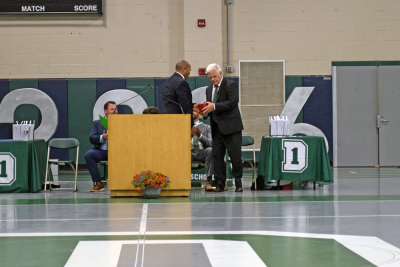 Marc Hayes gives Peter Rossi the Golden Apple. 