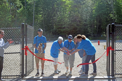 The Dog Advisory Work Group cuts the ribbon to open the park. 
