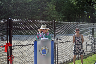 Select Board Chair Heidi Silva-Brooks welcomes people to the park. 