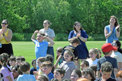 Some students celebrate the opening of the playground. 