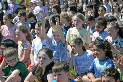 Some students celebrate the opening of the playground. 