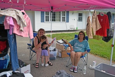 Destiny and Madeline pose at their yard sale.