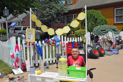 Adrian Rodriguez, age 7, selling lemonade at mhsi mom's yard sale. 