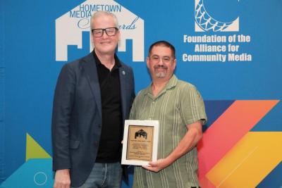 Peter Chasse accepting the award from Mike Wassenaar, the President and CEO of the Alliance for COmmunity Media. Source: Alliance for Community Media