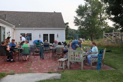 The DNRT, with people eating and the bonfire in the background. 