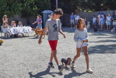 Florie and her brother walk their dachshund. 