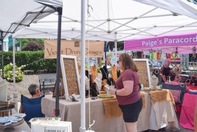 An attendee explores a jewelry booth. 