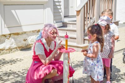 Kamryn, 3, waits for a balloon animal. 