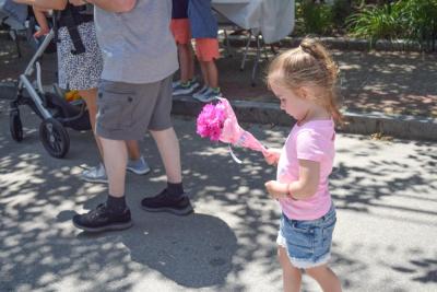 Rose, 3, carries her flowers. 
