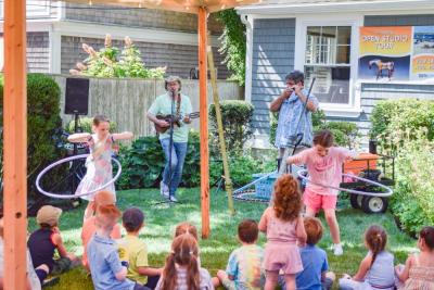 Two kids compete in a hula hoop contest held by the Toe Jam Puppet Band. 