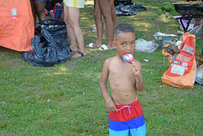 A kid enjoys an ice pop. 
