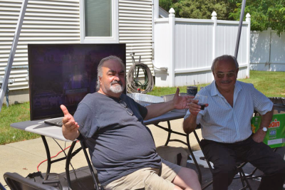 Two men pose for a photo. 