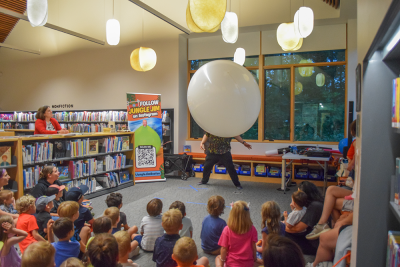Jungle Jim climbing into the balloon to show the kids the dinosaur. Photos by Kat Sheridan