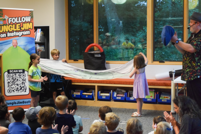 Arlo and Riley show off the dino they pulled from the bag. 