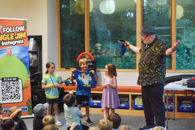 Grace, 7, Arlo and Riley participate in a magic act. Arlo accidentally pulled a chicken out of the bag, not a dino. 