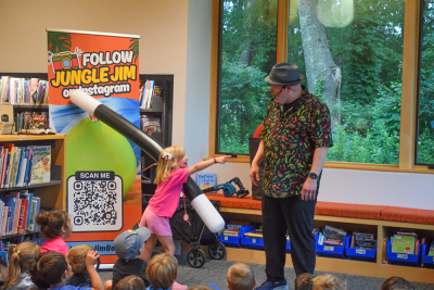 Ivy laughs at Jungle Jim after performing a magic trick. 
